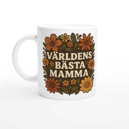 Mugg med texten 'Världens bästa mamma' omgiven av vackra blomster i varma nyanser. En perfekt hyllning till mamma.