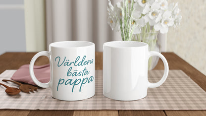 Mugg med texten 'Världens bästa pappa' i elegant handskriven font och varm blågrön färg. Perfekt till fars dag eller som uppskattning.