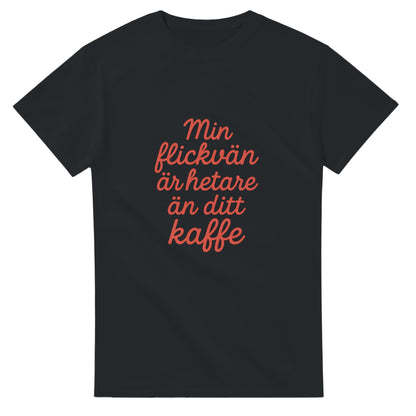 T-shirt med texten 'Min flickvän är hetare än ditt kaffe' i röd skrivstil. Perfekt för att visa kärlek med en touch av humor.