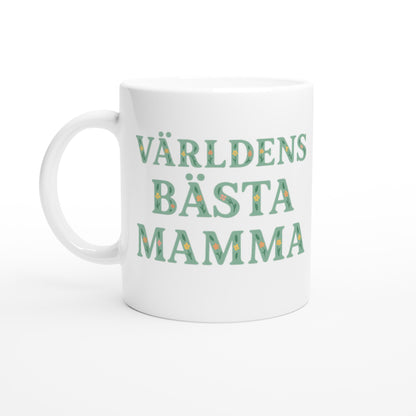 Mugg med blommigt mönster och texten 'Världens bästa mamma' i mjuk grön färg. Perfekt present till mamma.