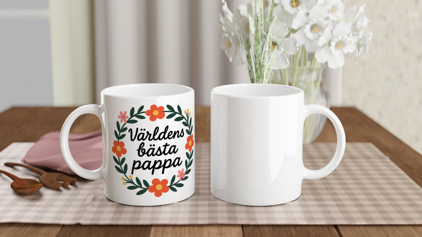 Mugg med texten 'Världens bästa pappa' i blomsterkrans, handskriven stil. Visa uppskattning.