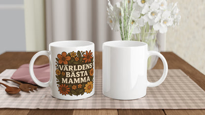 Mugg med texten 'Världens bästa mamma' omgiven av vackra blomster i varma nyanser. En perfekt hyllning till mamma.